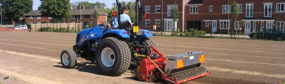 A new construction school playing field area being cultivated & levelled ready for grass seeding following drainage installation.